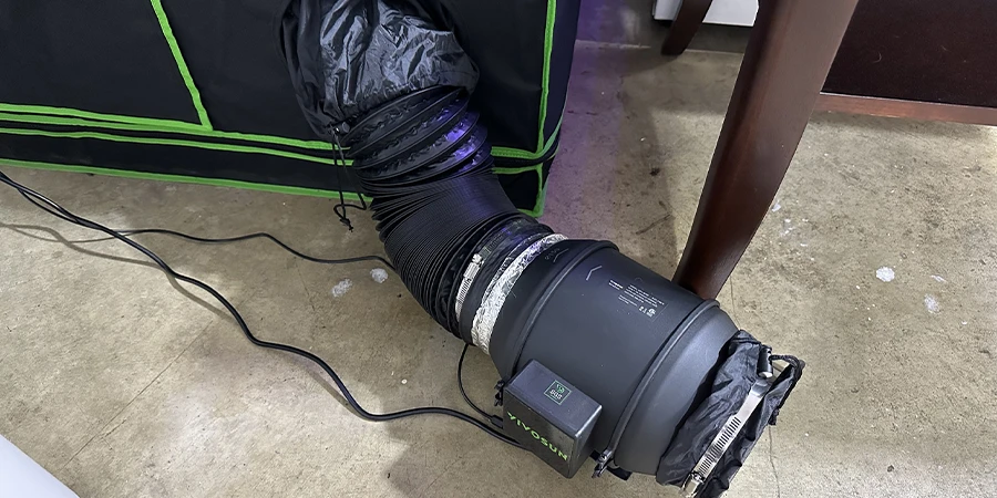 The exhaust fan setup in a grow tent, designed to expel hot air, control humidity, and maintain optimal environmental conditions for cannabis cultivation.