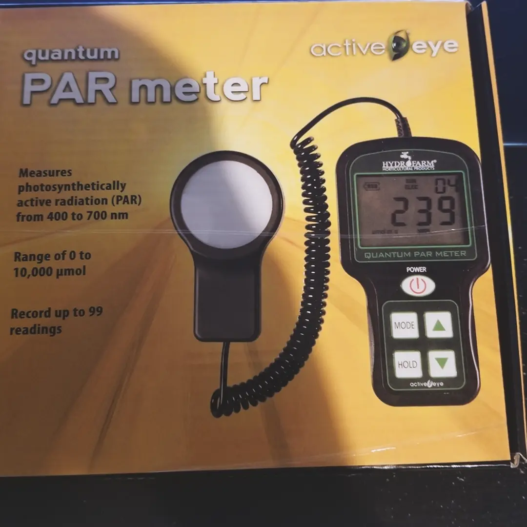 PAR meter with digital display and sensor, measuring photosynthetically active radiation (PAR) from 400 to 700 nm, in a yellow box.